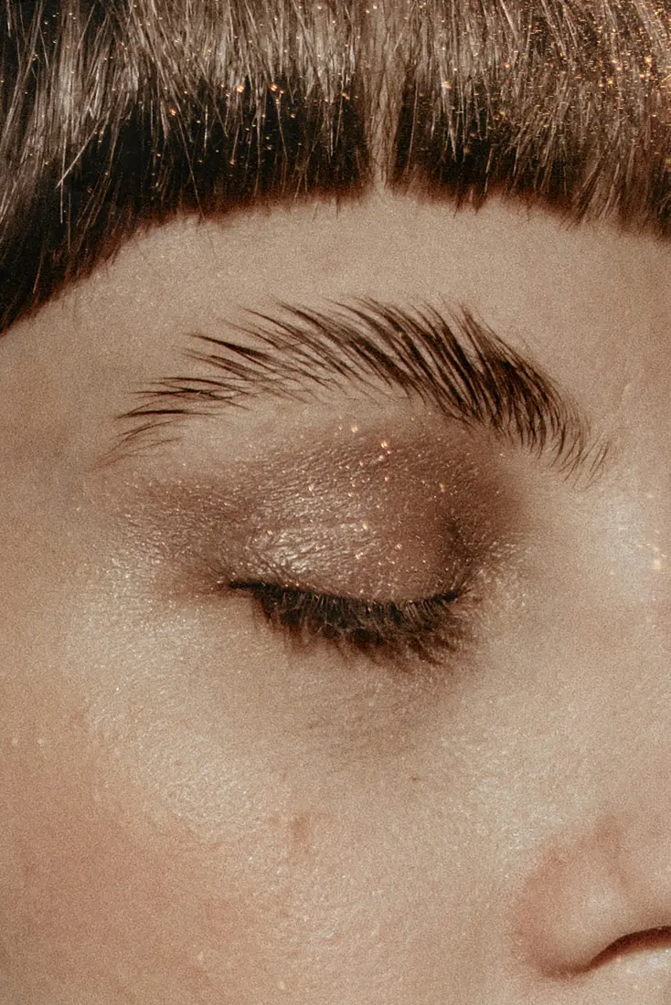 Close-up of a brushed-up eyebrow above a closed eye