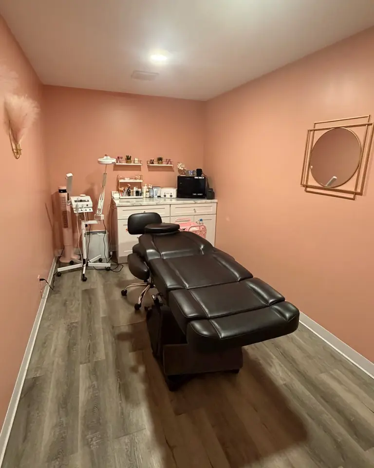 A Spathetics treatment room with a treatment chair and pink walls